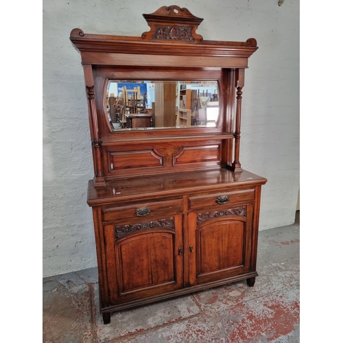 1043 - An Art Nouveau mahogany mirror back sideboard with two cupboard doors, two drawers, carved panel det... 