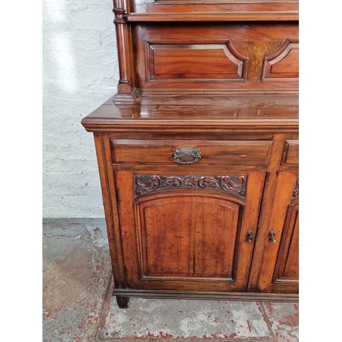 1043 - An Art Nouveau mahogany mirror back sideboard with two cupboard doors, two drawers, carved panel det... 