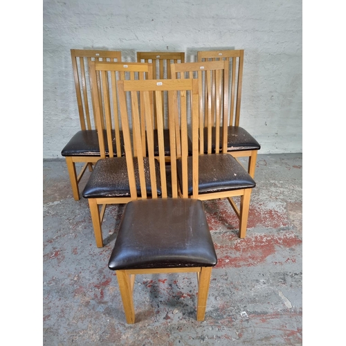 1050 - A set of six modern light oak high back dining chairs with brown leatherette seats - approx. 109cm h... 