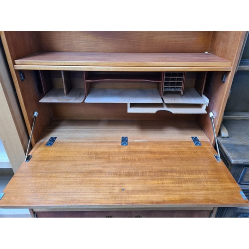 1135 - A 1960s teak bureau cabinet with two lower cupboard doors, fall front and upper shelf - approx. 167c... 