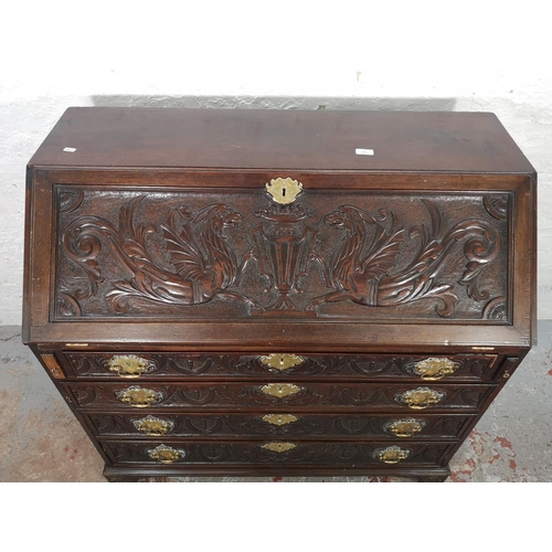 1001 - A Victorian Gothic Revival carved oak bureau with four drawers, fall front and fitted interior  - ap... 