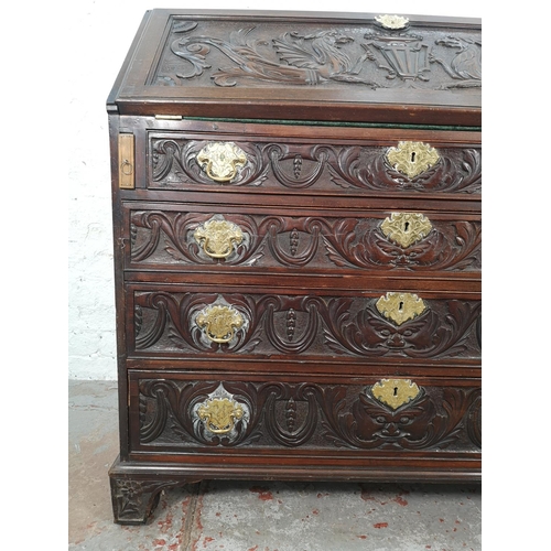 1001 - A Victorian Gothic Revival carved oak bureau with four drawers, fall front and fitted interior  - ap... 