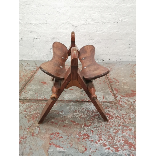 1004 - An Indian brass inlaid hardwood camel stool with brown leather cushion - approx. 43cm high x 40cm wi... 