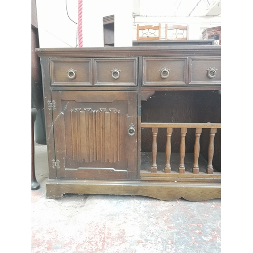 1005 - A late 20th century oak linenfold sideboard with three upper drawers and two lower cupboard doors - ... 