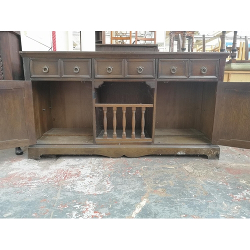 1005 - A late 20th century oak linenfold sideboard with three upper drawers and two lower cupboard doors - ... 