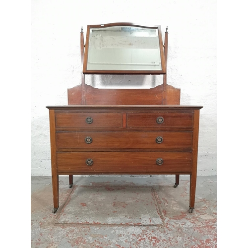 1011 - An Edwardian inlaid mahogany dressing chest with upper bevelled edge mirror, two short drawers and t... 