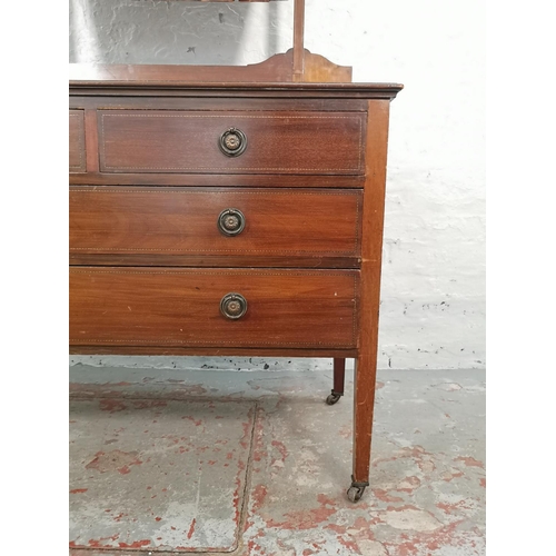 1011 - An Edwardian inlaid mahogany dressing chest with upper bevelled edge mirror, two short drawers and t... 