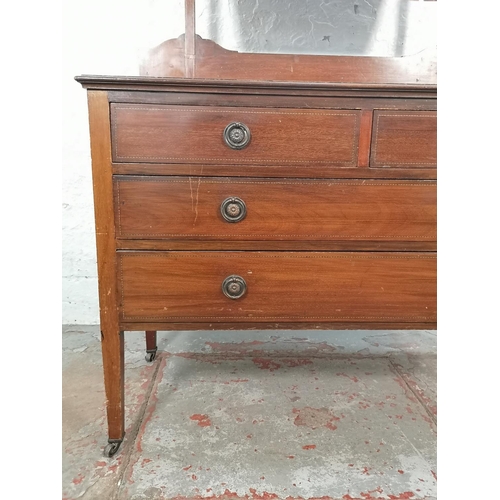 1011 - An Edwardian inlaid mahogany dressing chest with upper bevelled edge mirror, two short drawers and t... 