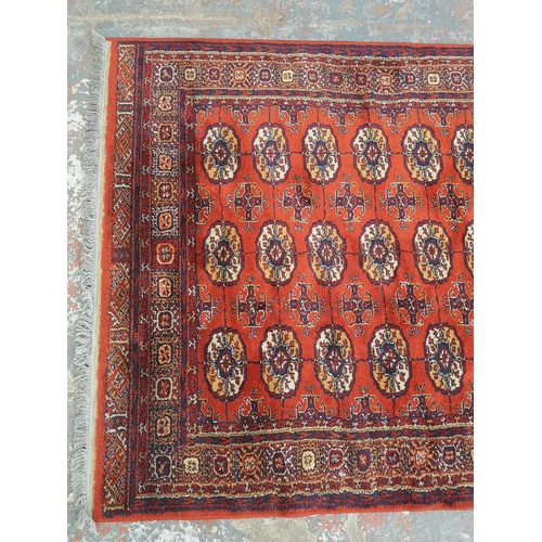 1012 - A red Bokhara rug - approx. 170cm long x 133cm wide