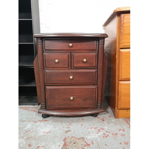 1019 - Five pieces of furniture, two brown leatherette six tier CD racks, one pine bedside chest of three d... 