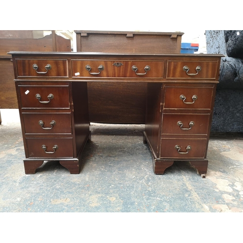 1022 - A 19th century style mahogany pedestal desk with green leather insert and nine drawers - approx. 77c... 