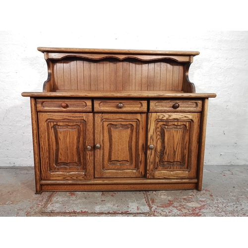 1024 - A late 20th century oak sideboard with three drawers and three lower cupboard doors - approx. 116cm ... 