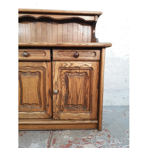 1024 - A late 20th century oak sideboard with three drawers and three lower cupboard doors - approx. 116cm ... 