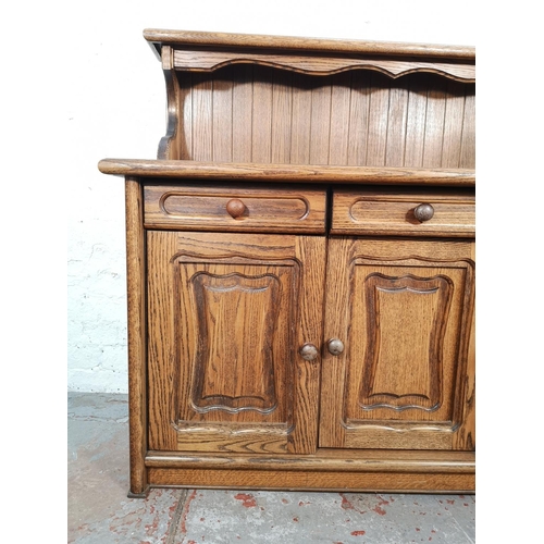 1024 - A late 20th century oak sideboard with three drawers and three lower cupboard doors - approx. 116cm ... 