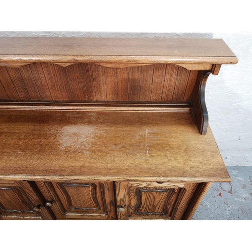 1024 - A late 20th century oak sideboard with three drawers and three lower cupboard doors - approx. 116cm ... 