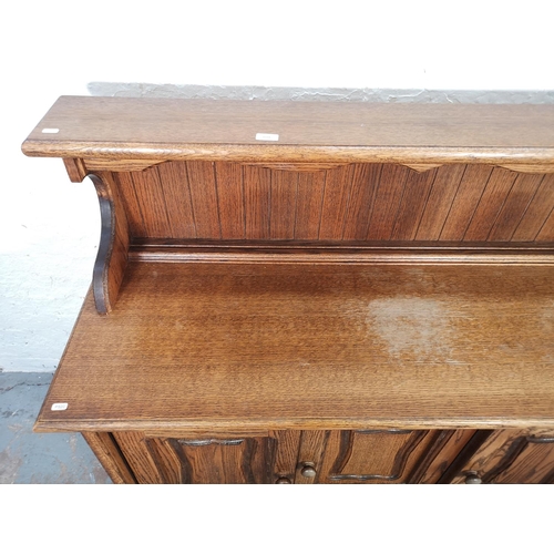 1024 - A late 20th century oak sideboard with three drawers and three lower cupboard doors - approx. 116cm ... 