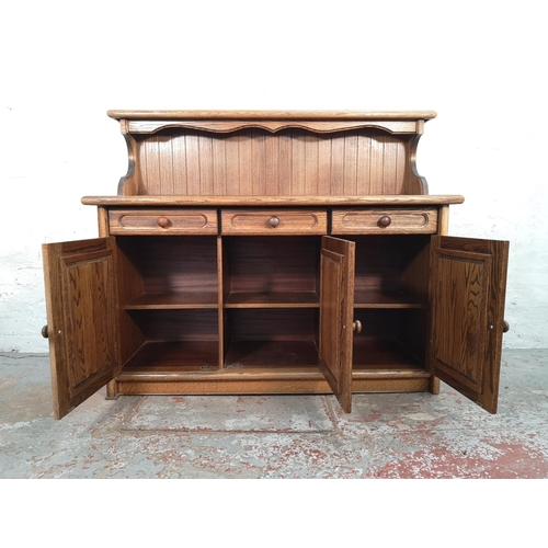 1024 - A late 20th century oak sideboard with three drawers and three lower cupboard doors - approx. 116cm ... 