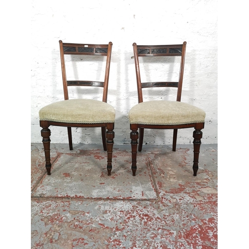 1026 - A pair of Edwardian carved mahogany and ebonised dining chairs with green upholstery