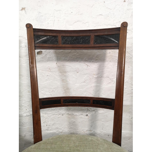 1026 - A pair of Edwardian carved mahogany and ebonised dining chairs with green upholstery