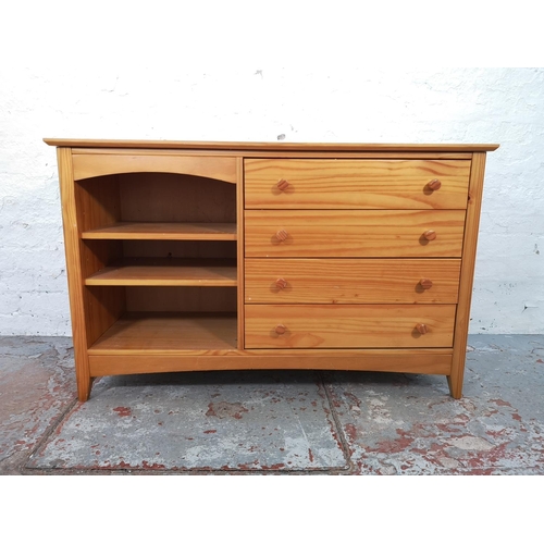 1027 - A modern pine sideboard with four drawers and three shelves - approx. 72cm high x 116cm wide x 40cm ... 