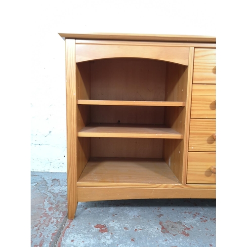 1027 - A modern pine sideboard with four drawers and three shelves - approx. 72cm high x 116cm wide x 40cm ... 