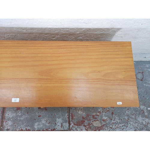 1027 - A modern pine sideboard with four drawers and three shelves - approx. 72cm high x 116cm wide x 40cm ... 