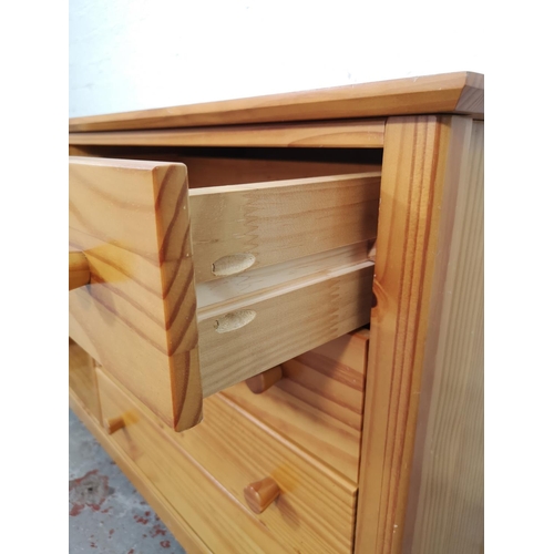 1027 - A modern pine sideboard with four drawers and three shelves - approx. 72cm high x 116cm wide x 40cm ... 