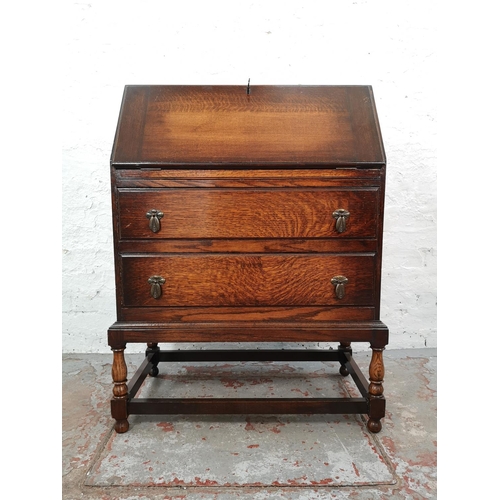 1028 - A 1930s oak bureau with two drawers, fall front and fitted interior - approx. 99cm high x 72cm wide ... 