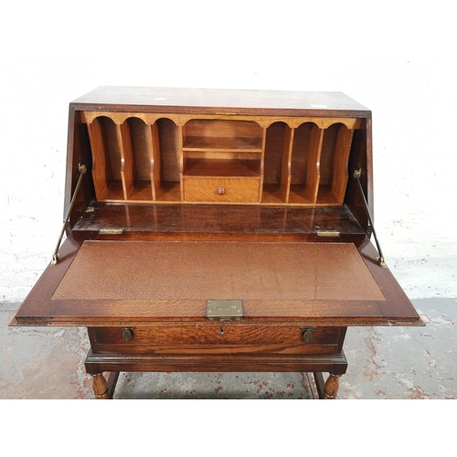 1028 - A 1930s oak bureau with two drawers, fall front and fitted interior - approx. 99cm high x 72cm wide ... 