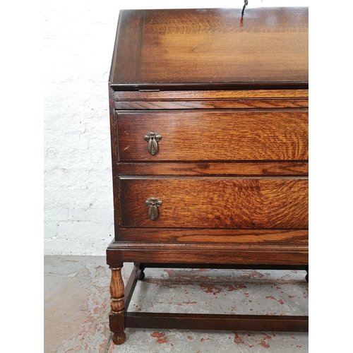 1028 - A 1930s oak bureau with two drawers, fall front and fitted interior - approx. 99cm high x 72cm wide ... 