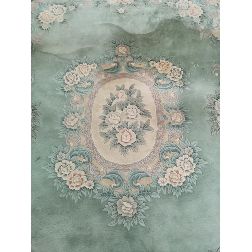 1032 - A large Chinese green rug - approx. 389cm x 278cm