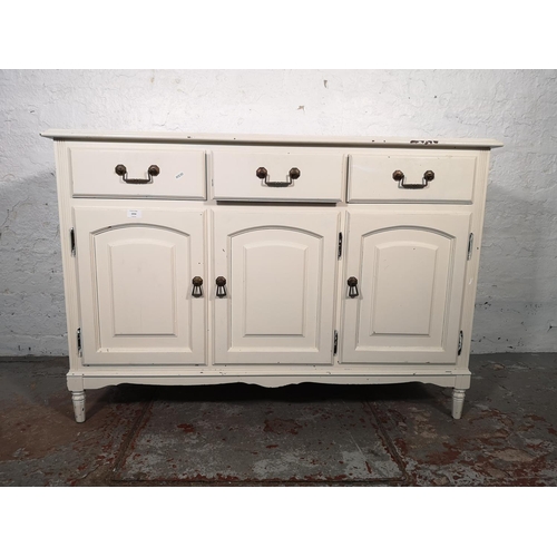 1034 - A modern white painted sideboard with three drawers and three lower cupboard doors - approx. 84cm hi... 