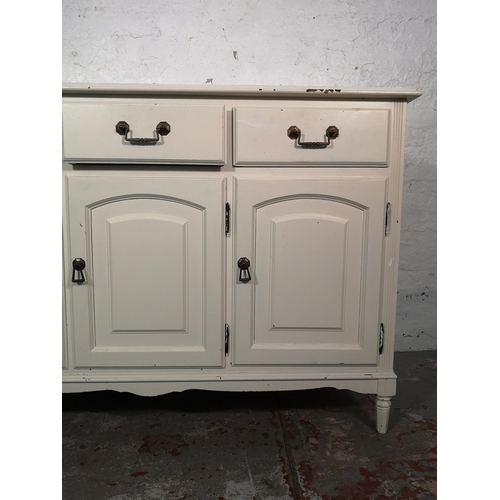 1034 - A modern white painted sideboard with three drawers and three lower cupboard doors - approx. 84cm hi... 