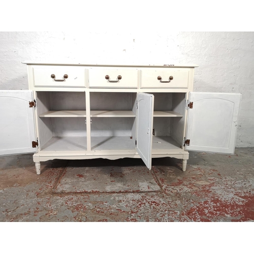 1034 - A modern white painted sideboard with three drawers and three lower cupboard doors - approx. 84cm hi... 