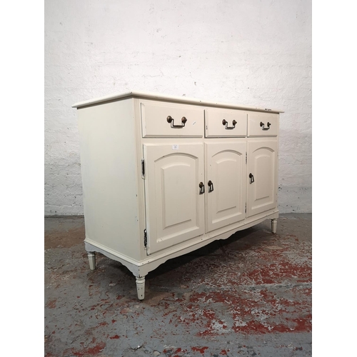 1034 - A modern white painted sideboard with three drawers and three lower cupboard doors - approx. 84cm hi... 