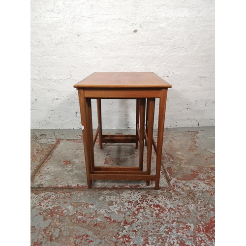 1038A - A teak nest of three tables - largest approx. 52cm high x 54cm wide x 39cm deep