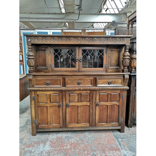 1039 - A 17th century style oak court cupboard with carved pillar supports - approx. 137cm high x 137cm wid... 