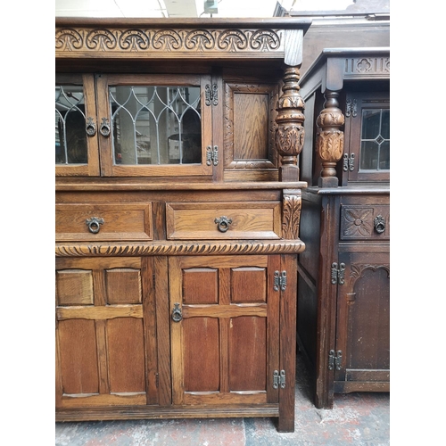 1039 - A 17th century style oak court cupboard with carved pillar supports - approx. 137cm high x 137cm wid... 