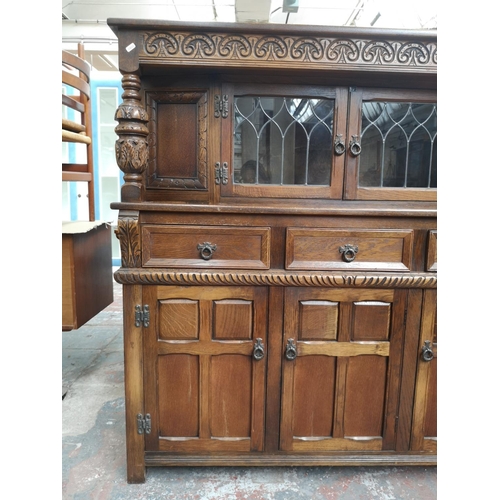 1039 - A 17th century style oak court cupboard with carved pillar supports - approx. 137cm high x 137cm wid... 