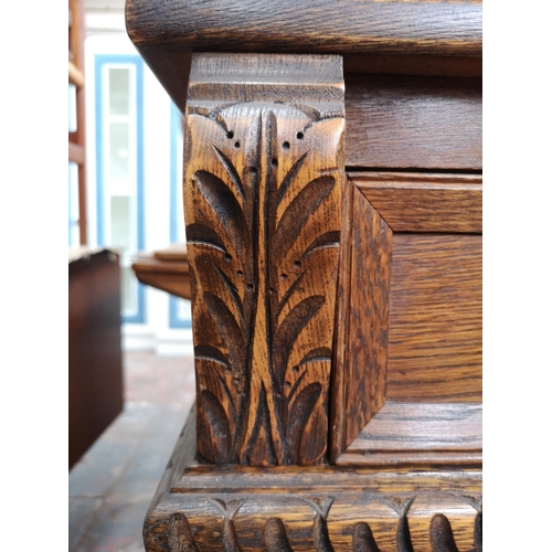 1039 - A 17th century style oak court cupboard with carved pillar supports - approx. 137cm high x 137cm wid... 