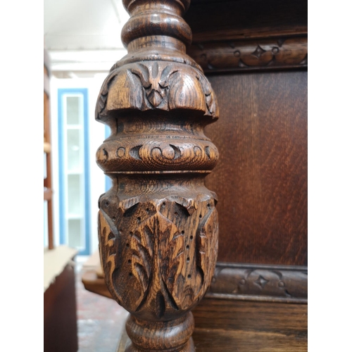 1039 - A 17th century style oak court cupboard with carved pillar supports - approx. 137cm high x 137cm wid... 