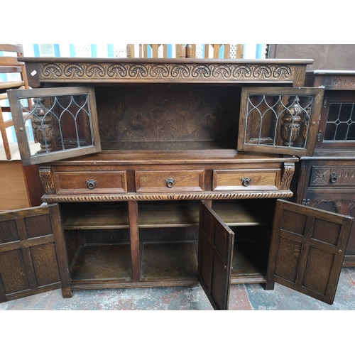 1039 - A 17th century style oak court cupboard with carved pillar supports - approx. 137cm high x 137cm wid... 