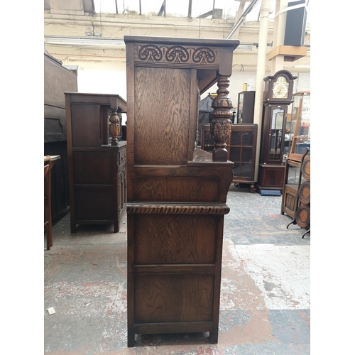 1039 - A 17th century style oak court cupboard with carved pillar supports - approx. 137cm high x 137cm wid... 