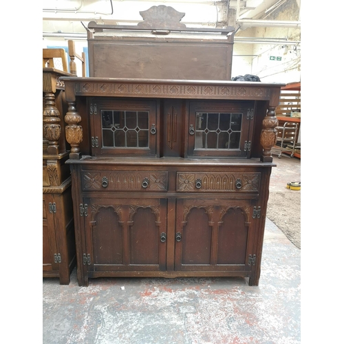 1041 - A 17th century style oak court cupboard with carved pillar supports - approx. 133cm high x 126cm wid... 