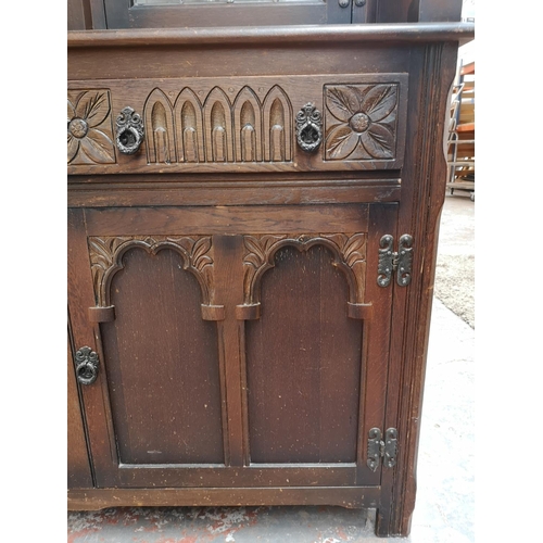 1041 - A 17th century style oak court cupboard with carved pillar supports - approx. 133cm high x 126cm wid... 