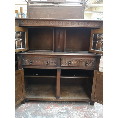 1041 - A 17th century style oak court cupboard with carved pillar supports - approx. 133cm high x 126cm wid... 