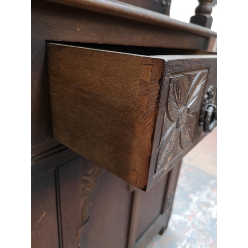 1041 - A 17th century style oak court cupboard with carved pillar supports - approx. 133cm high x 126cm wid... 