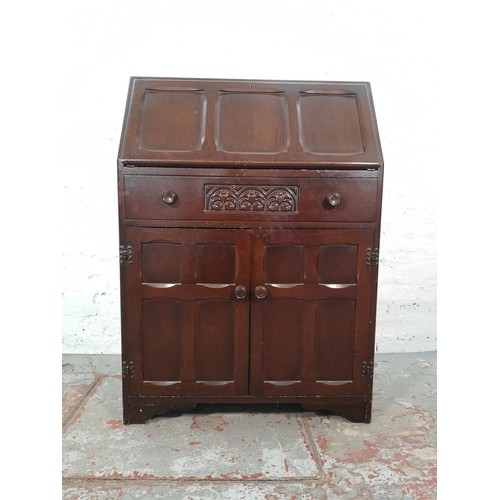 1042 - A mid 20th century oak bureau with two lower cupboard doors, single drawer and fall front - approx. ... 