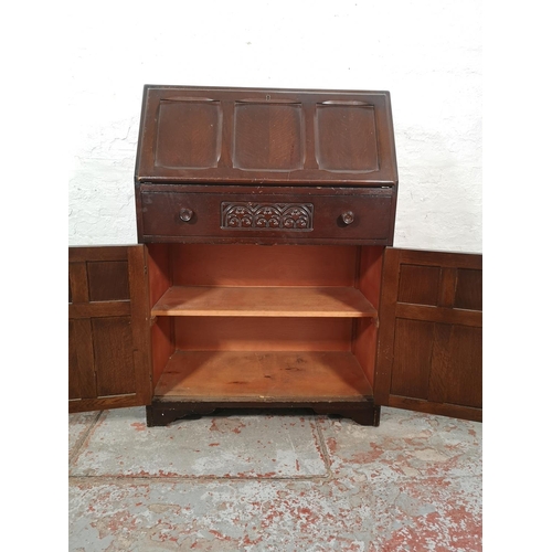 1042 - A mid 20th century oak bureau with two lower cupboard doors, single drawer and fall front - approx. ... 