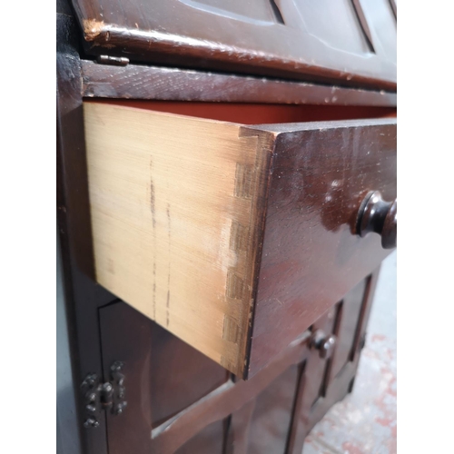 1042 - A mid 20th century oak bureau with two lower cupboard doors, single drawer and fall front - approx. ... 